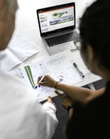 woman in white shirt writing on white paper