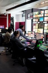 man in black and white checkered dress shirt sitting on black office rolling chair