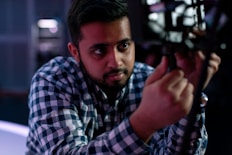 man in blue and white plaid dress shirt