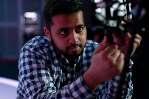 man in blue and white plaid dress shirt