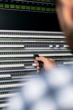 person holding gray and black audio mixer