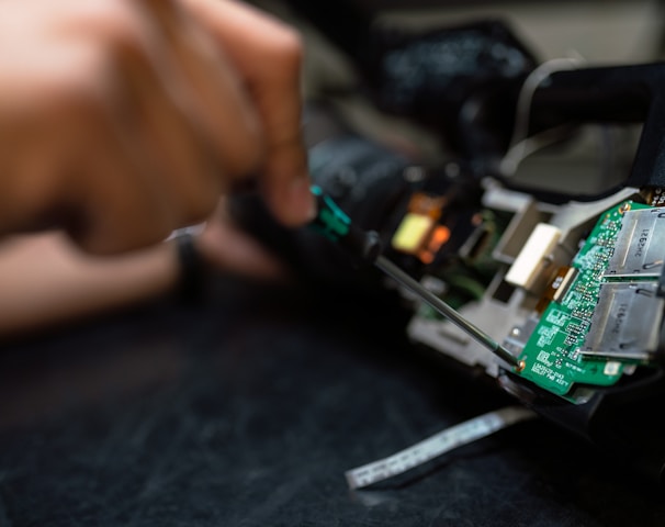 person holding green and black circuit board