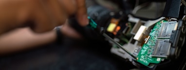 person holding green and black circuit board