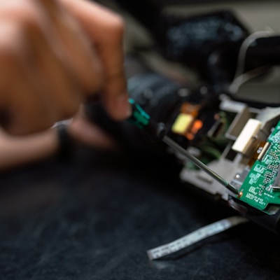 person holding green and black circuit board