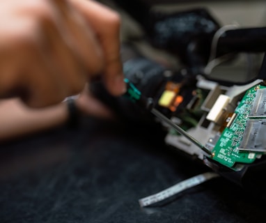 person holding green and black circuit board