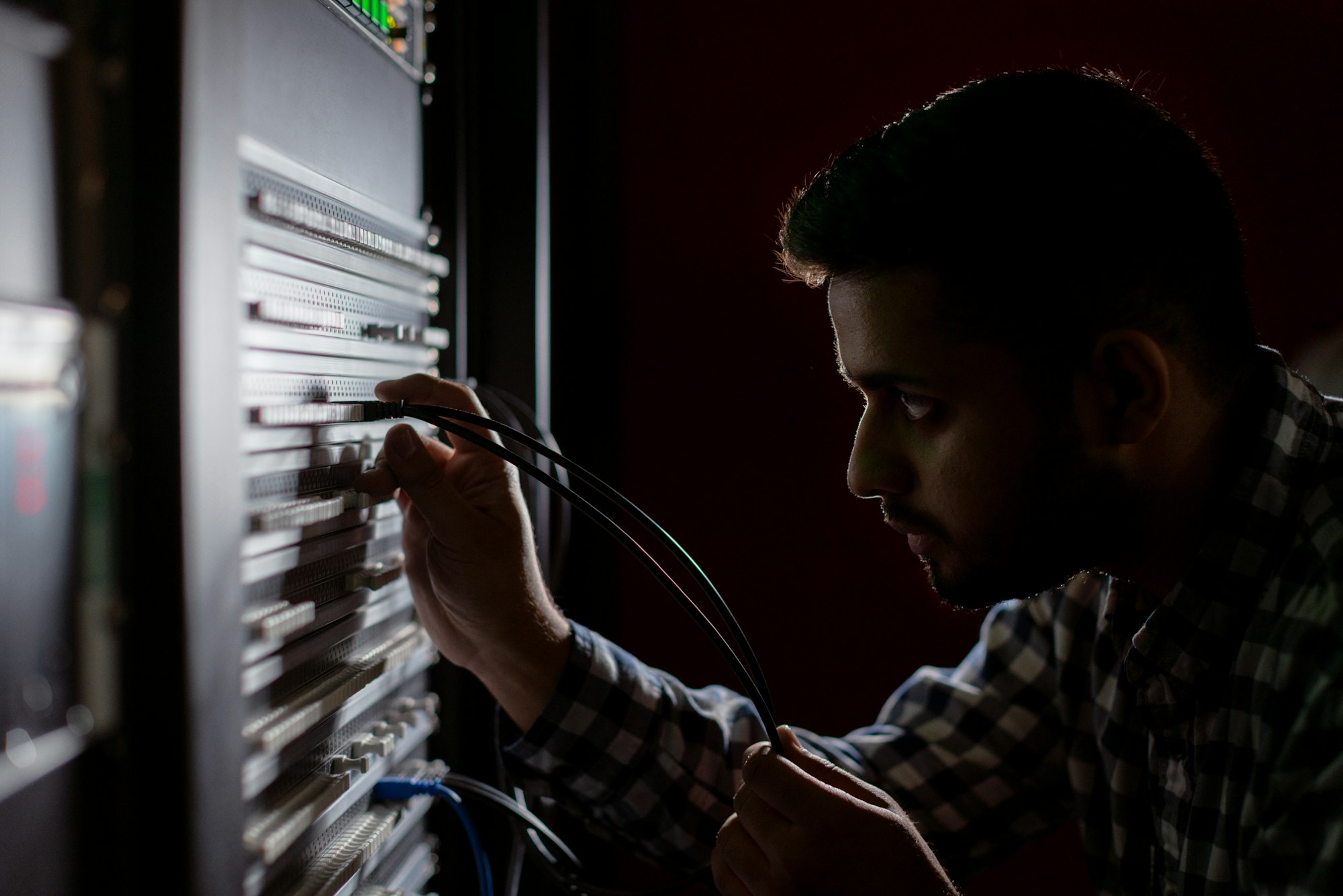 Male broadcast engineer works in studio