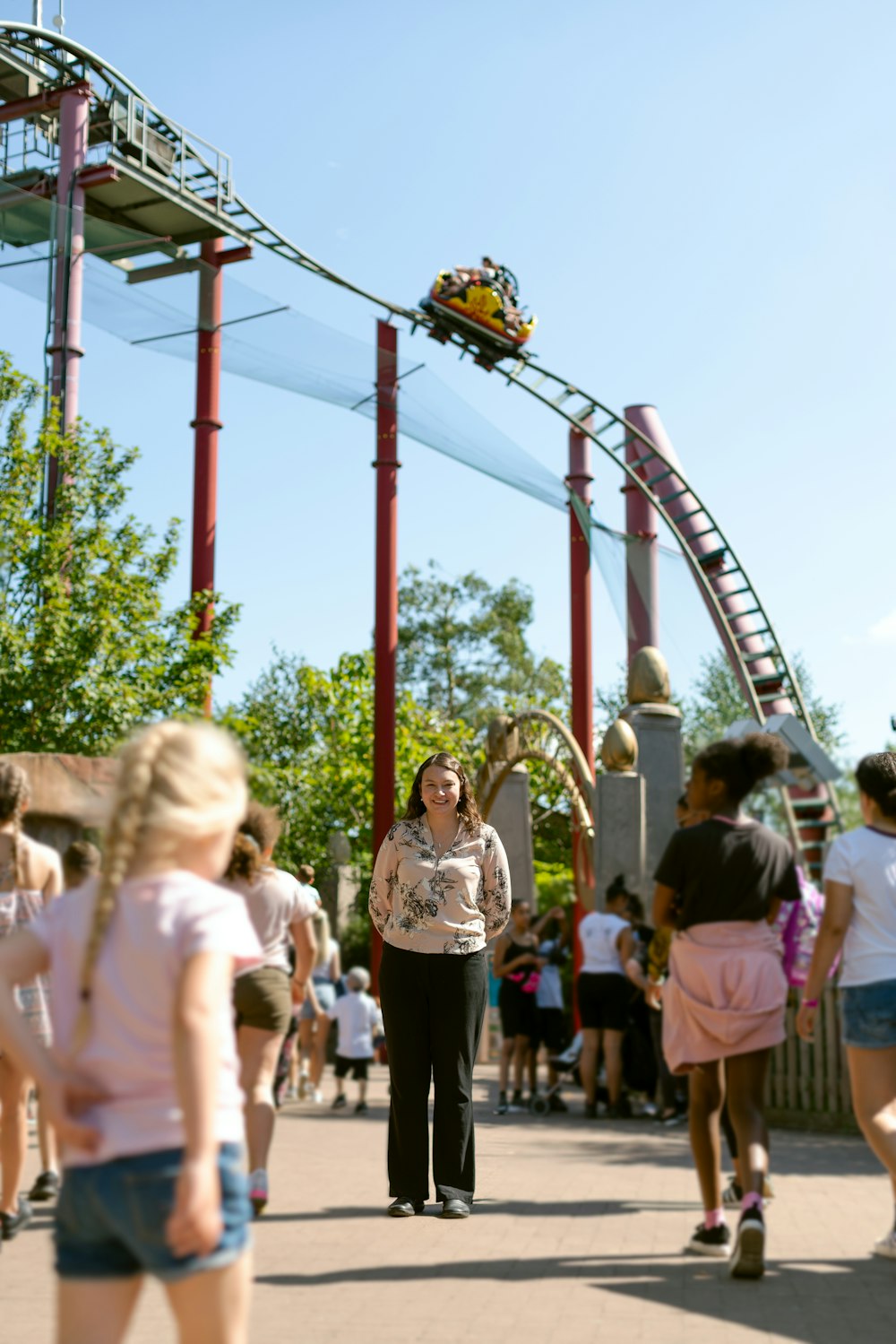 people standing on red and white metal tower during daytime