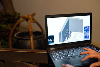 black and silver laptop computer on brown wooden table