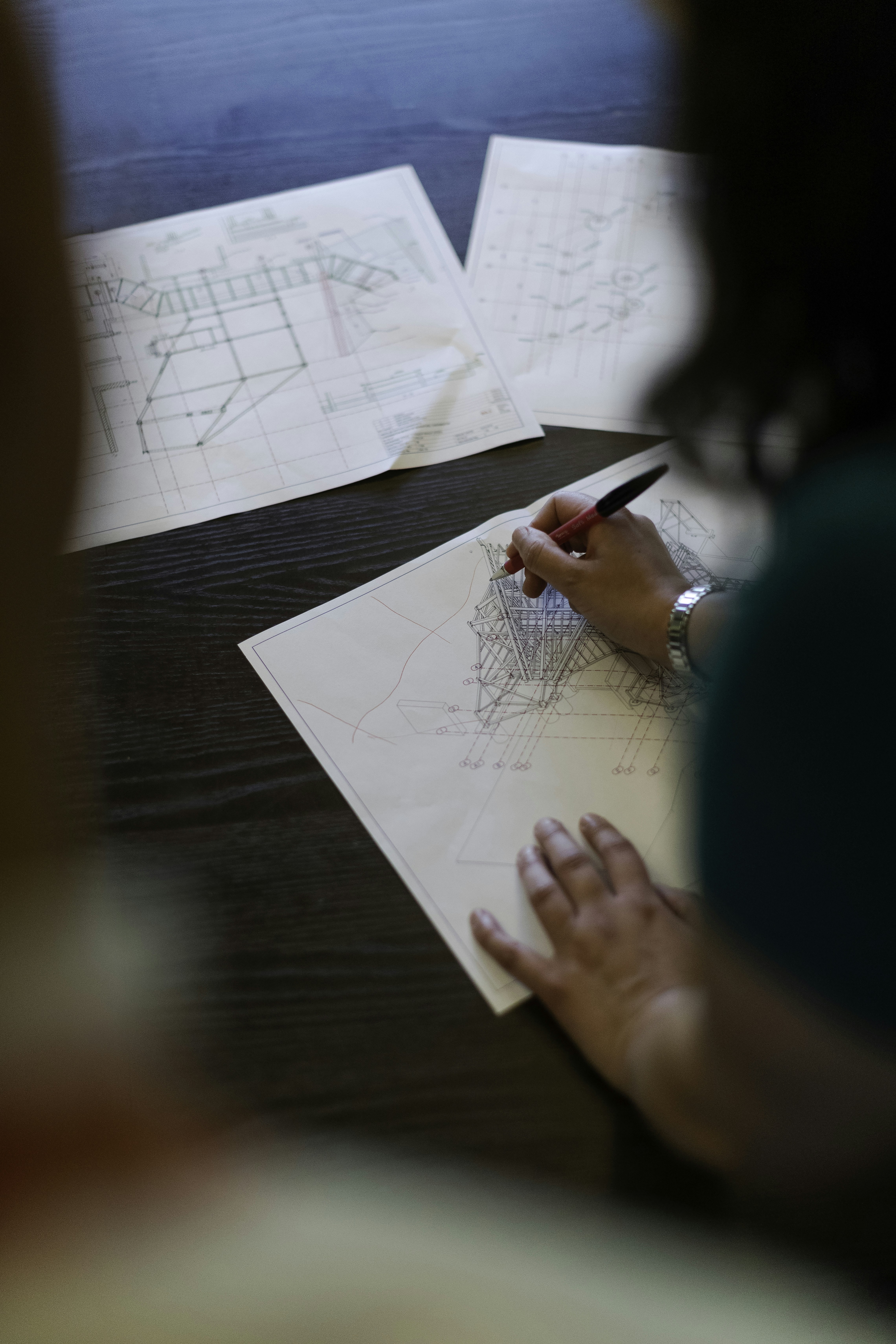 Project manager reviewing blueprints with a team on site 