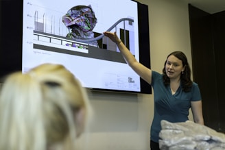 woman in blue shirt holding clear glass bowl