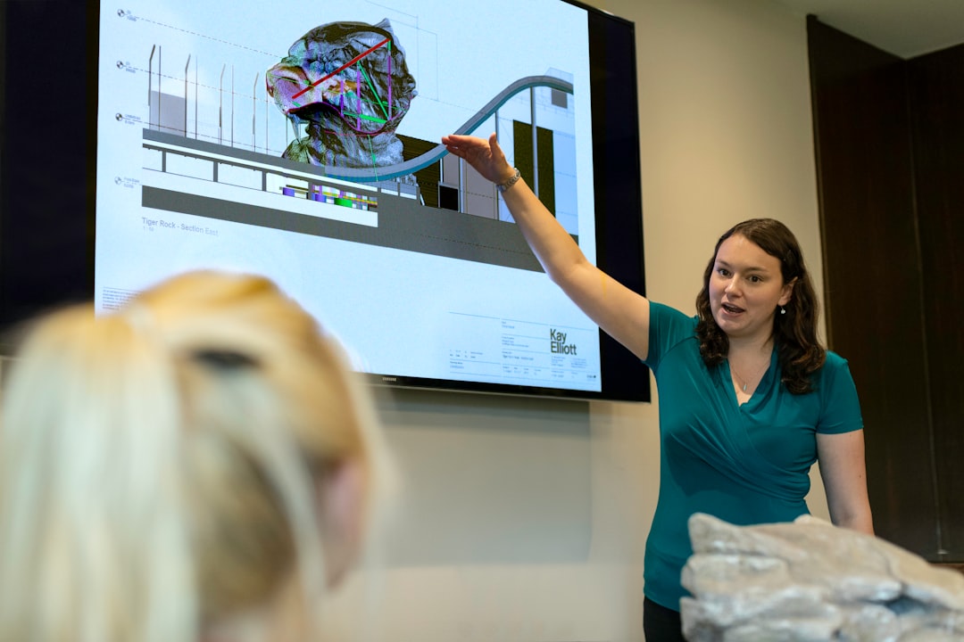 woman in blue shirt holding clear glass bowl, Female civil engineer presents theme park ride mechanics