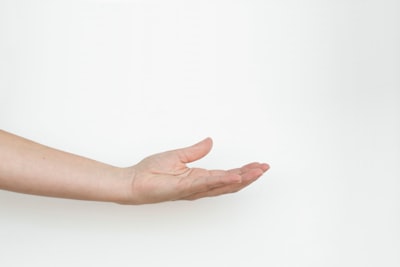 persons hand on white surface hand zoom background