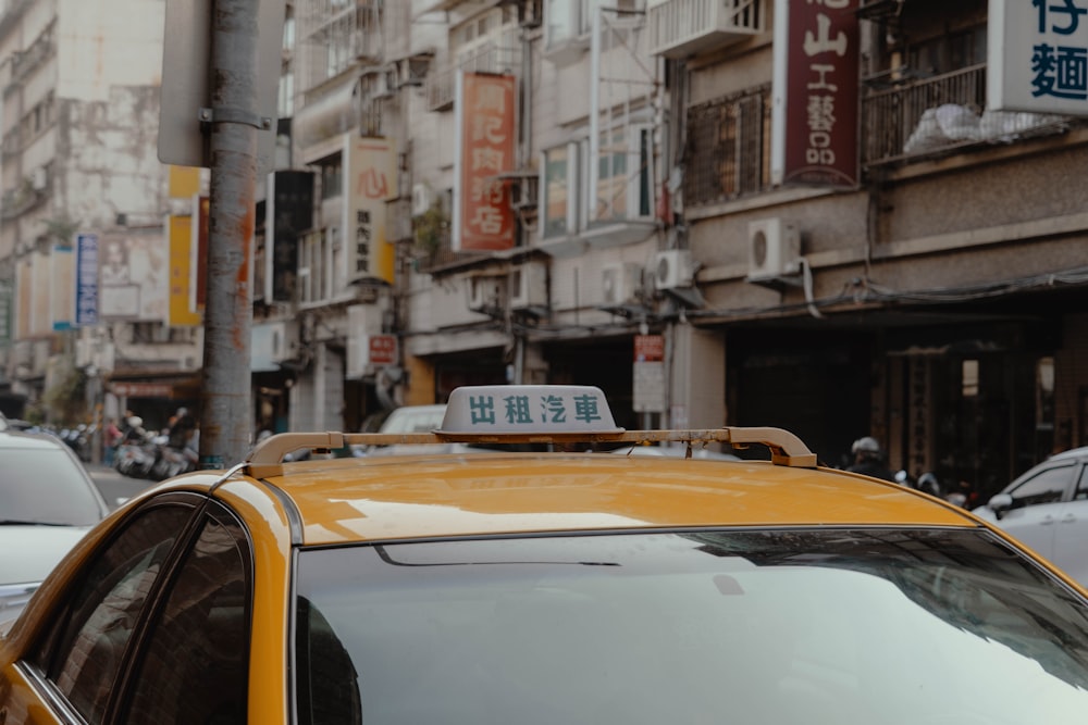 yellow and white taxi cab on road during daytime