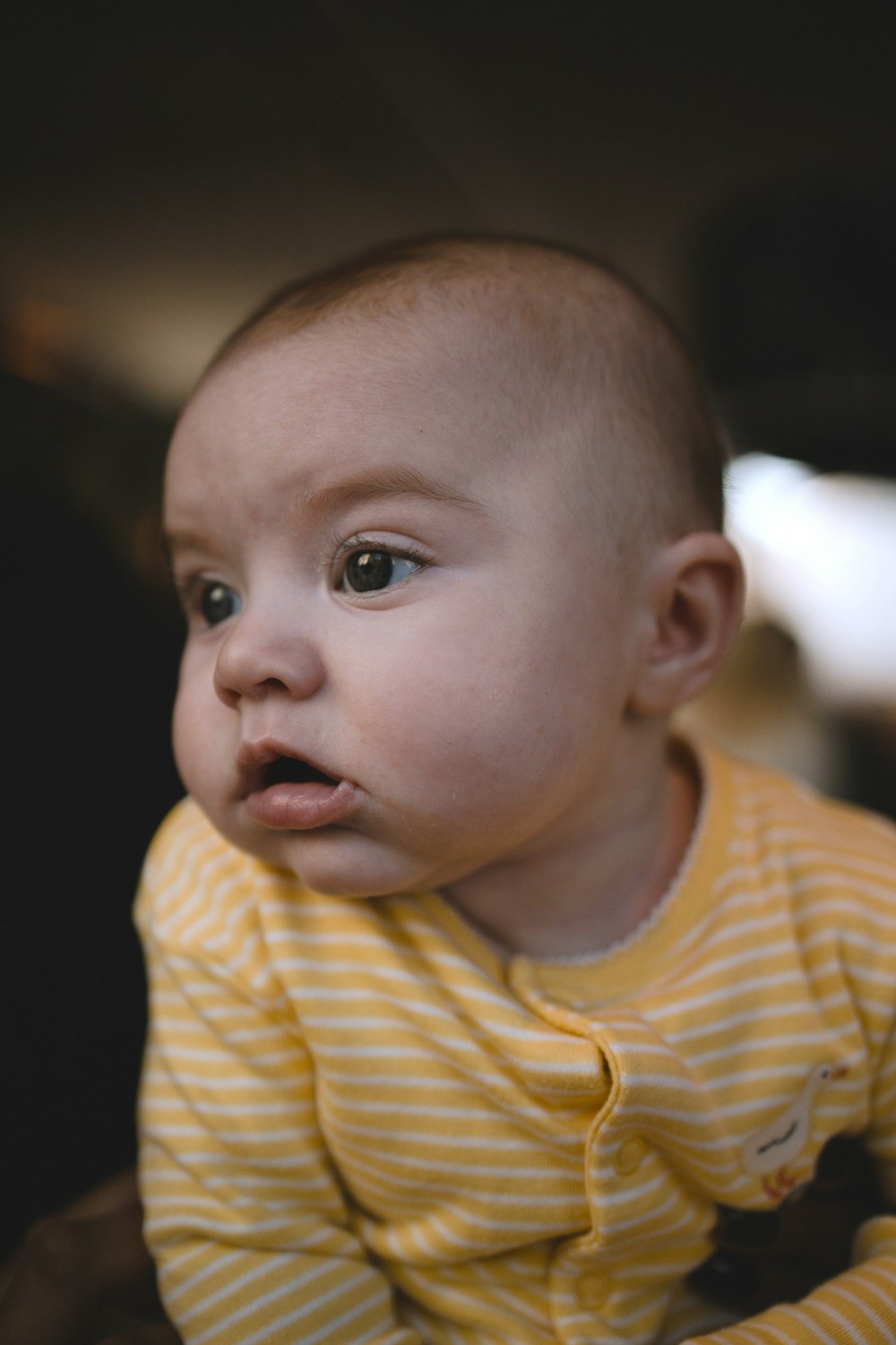 baby in yellow and white striped shirt