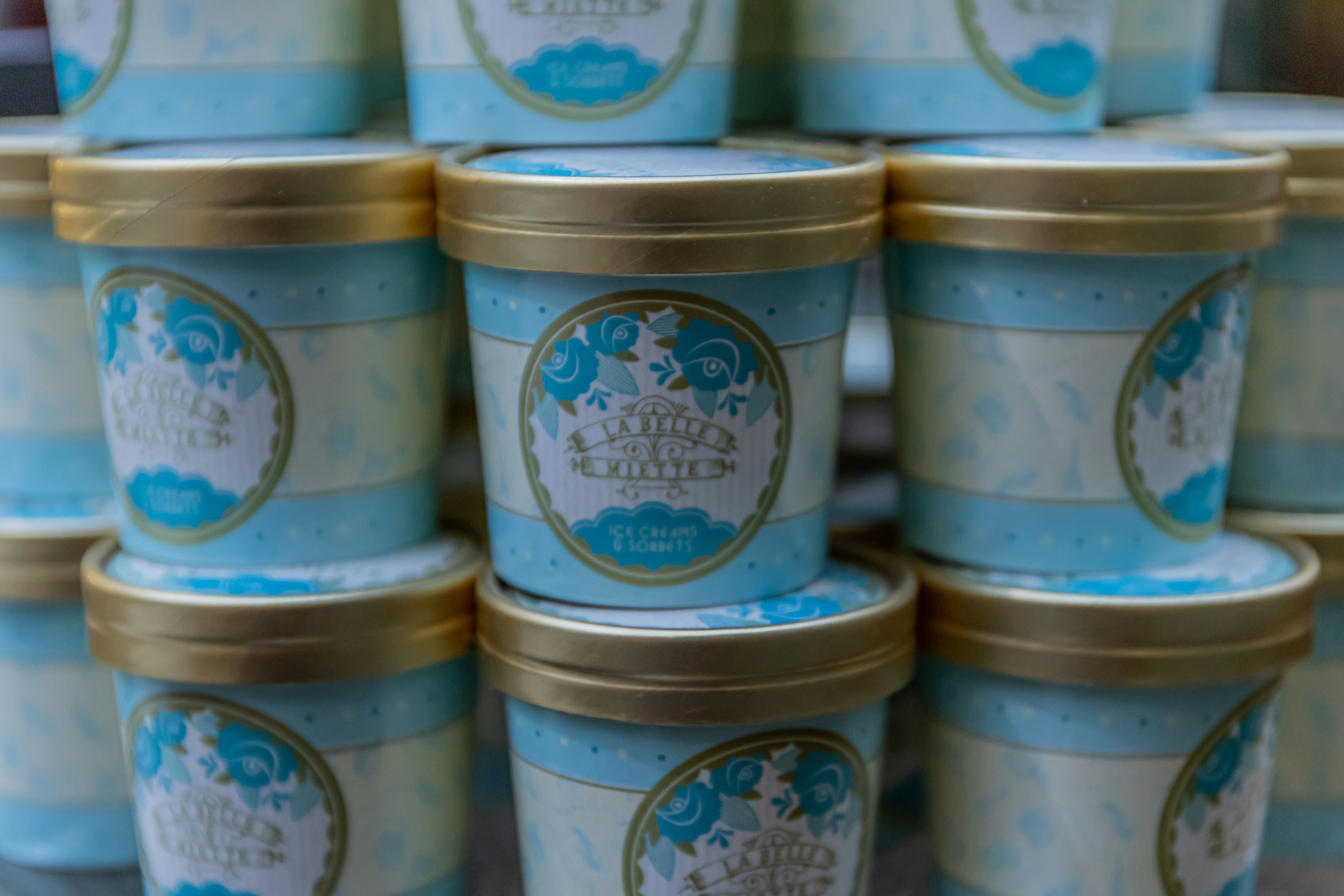 Two colourful ice cream tubs side by side on a bright clean surface