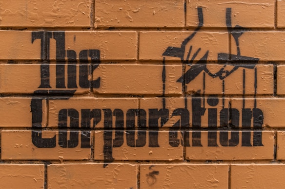 Stencil graffiti art on a brick wall features the words 
