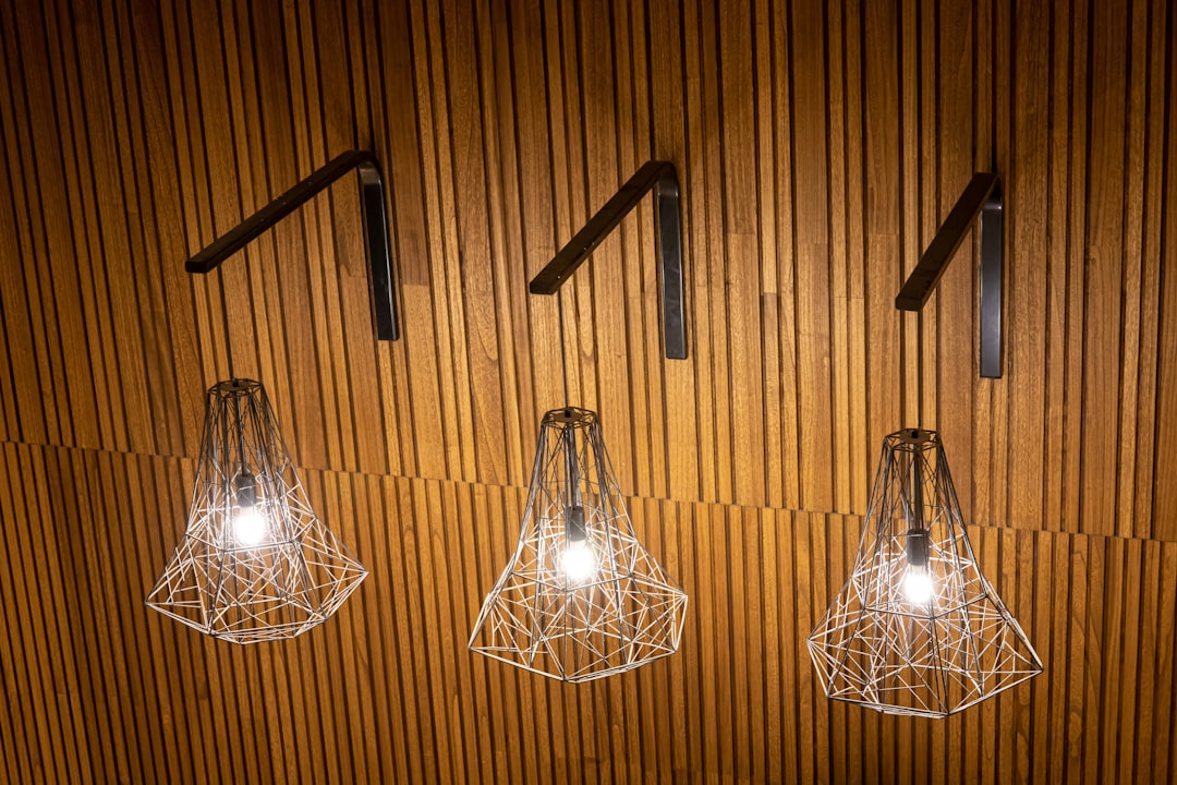 silver framed pendant lamp turned on in room