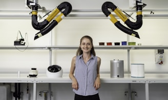 woman in blue sleeveless shirt holding black and yellow power tool