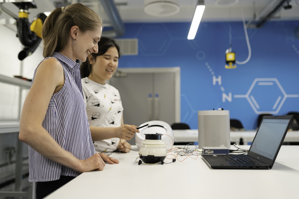 woman in white and black polka dot shirt holding white headphones