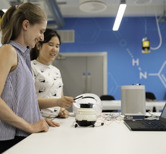 woman in white and black polka dot shirt holding white headphones