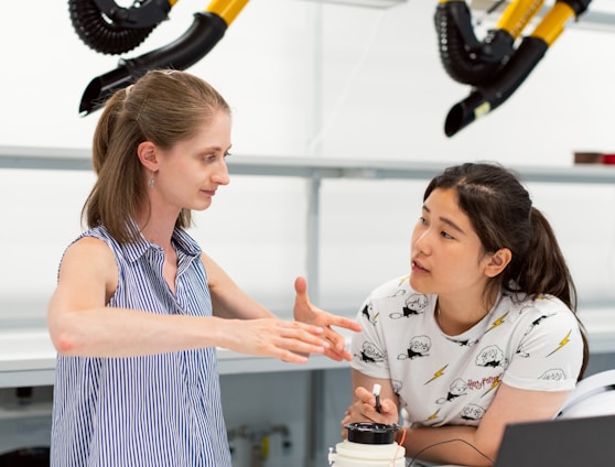 woman in white and blue stripe tank top holding black and yellow power tool