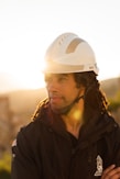 man in black jacket wearing white helmet
