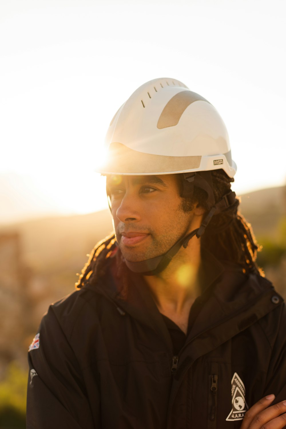 man in black jacket wearing white helmet