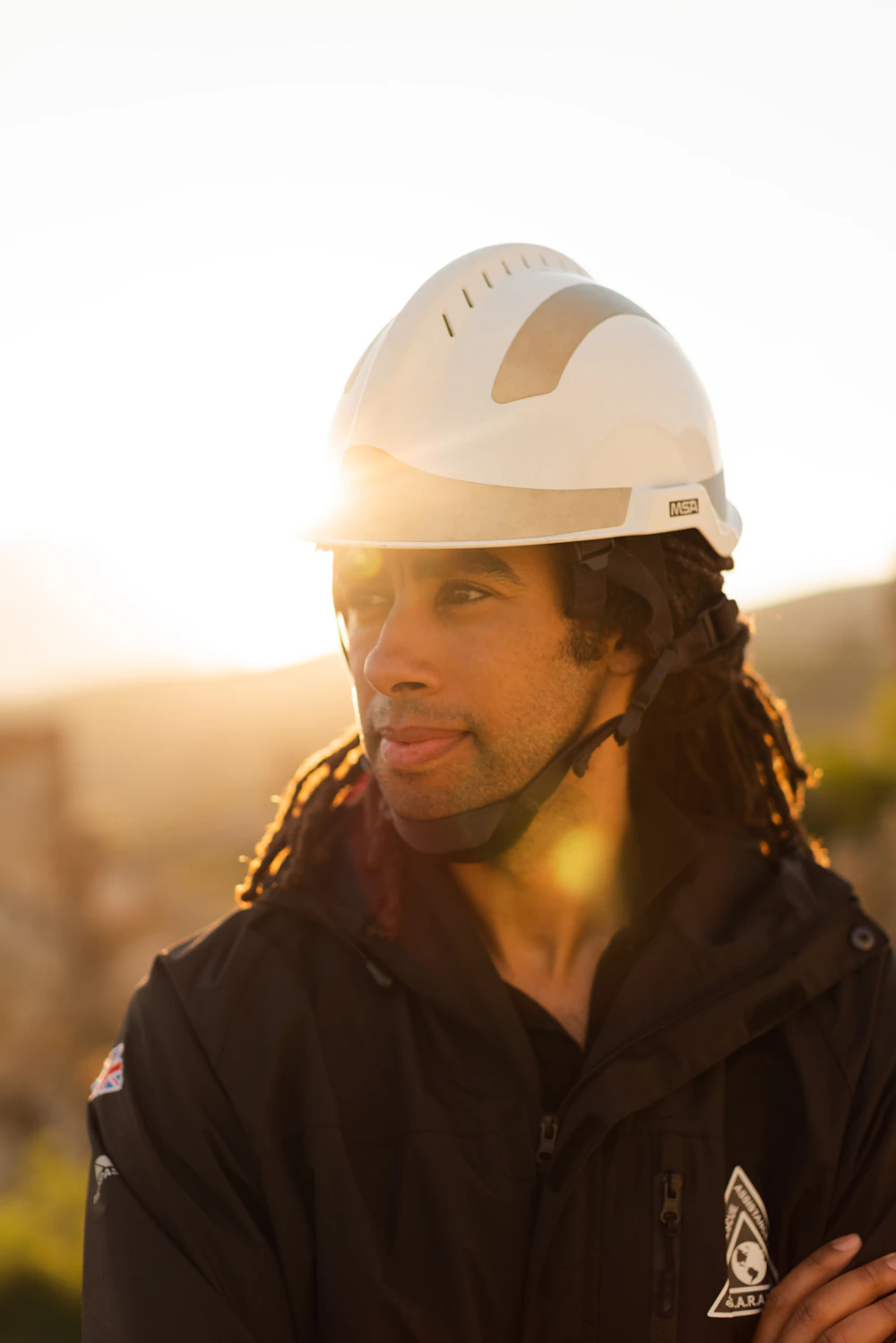 Worker in a hard hat at golden hour