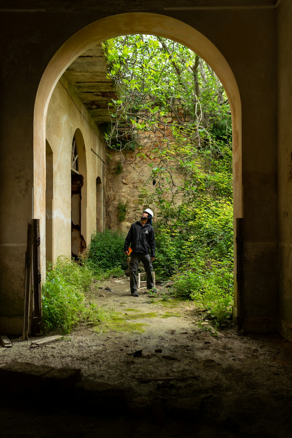 man in black jacket and black pants walking on pathway