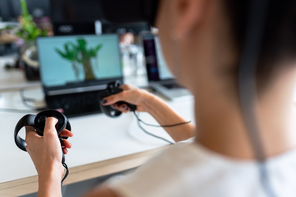 person holding black game controller