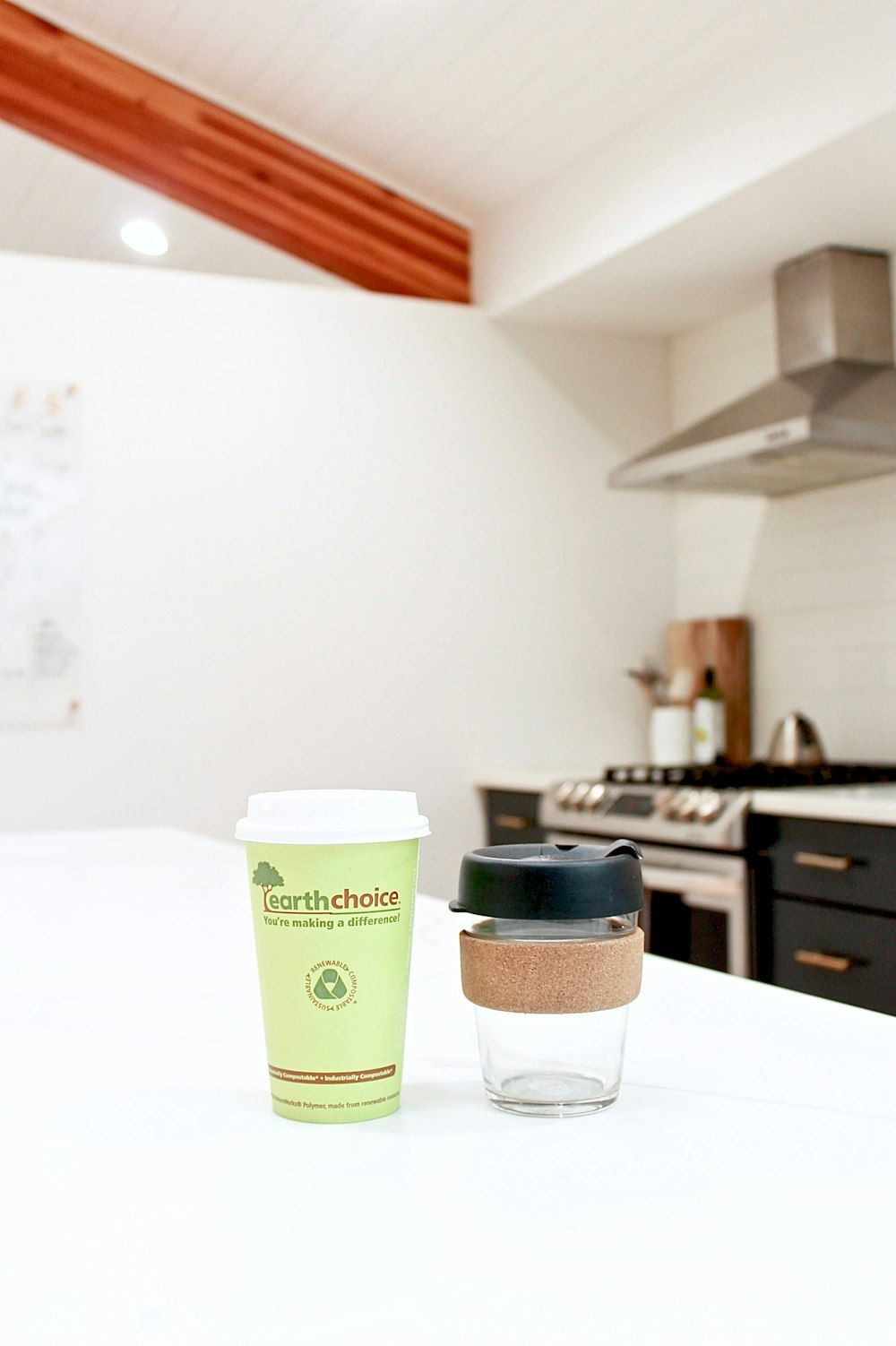 white and green starbucks disposable cup on white table