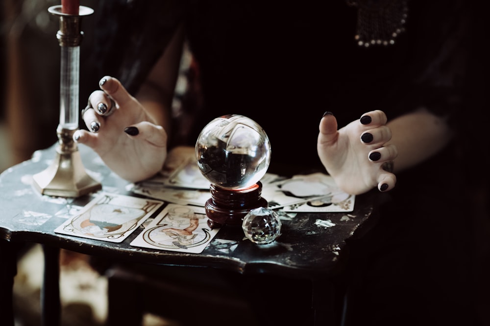 person holding clear glass ball