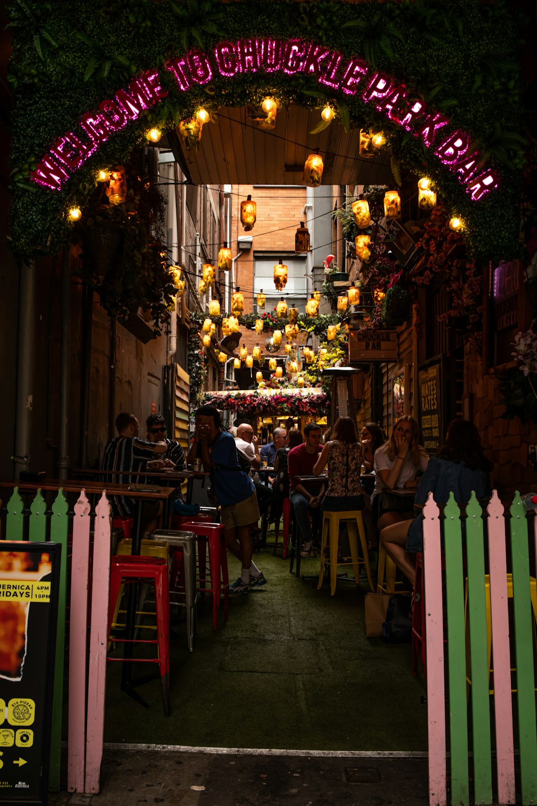 people sitting on chair near store during night time