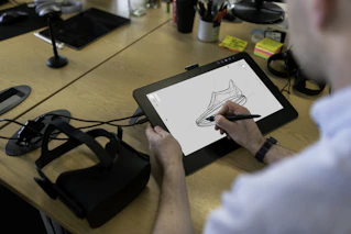 Designer drawing animation frames on a graphics tablet