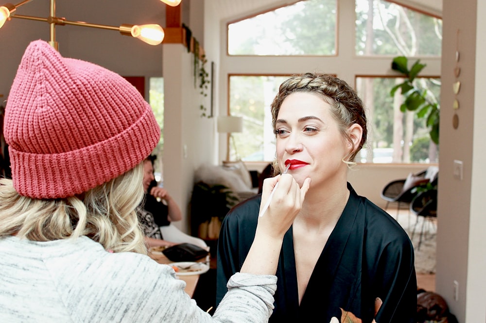 woman in red knit cap and gray long sleeve shirt