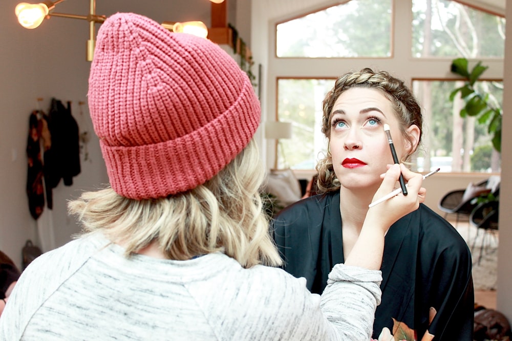 woman in gray long sleeve shirt wearing red knit cap