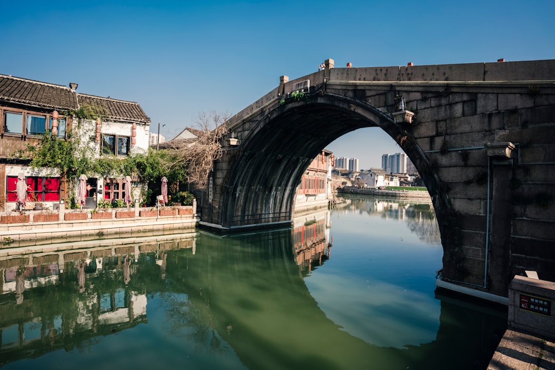 brown concrete bridge over river during daytime