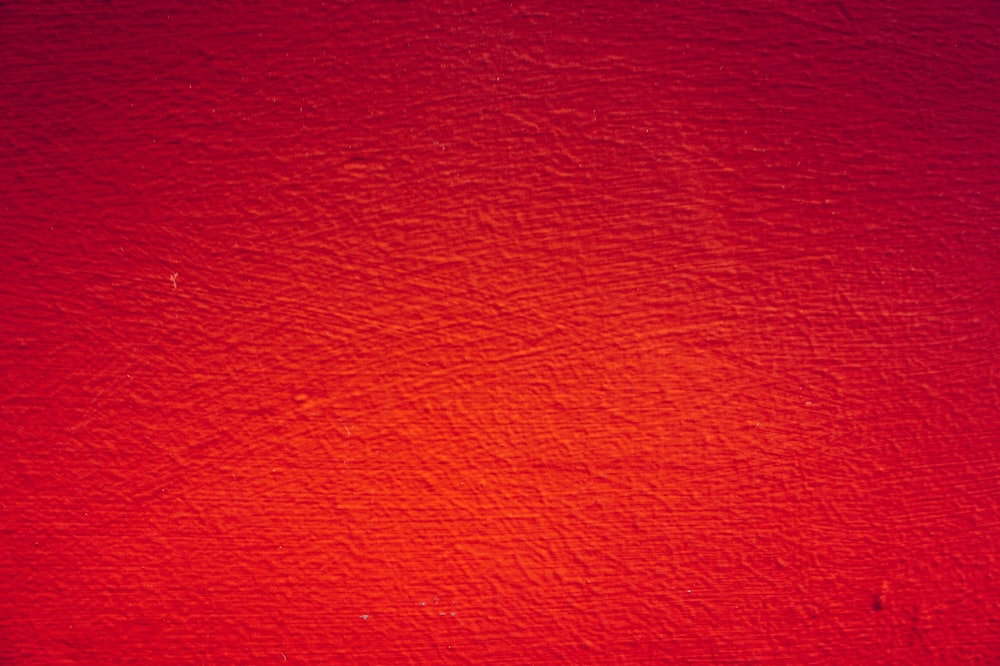 red painted wall in close up photography