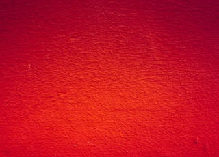 red painted wall in close up photography