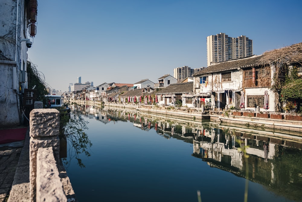 body of water between buildings during daytime