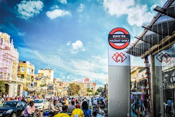 A vibrant street scene in Bareilly bustling with people, shops, and colorful signs under a bright sky.