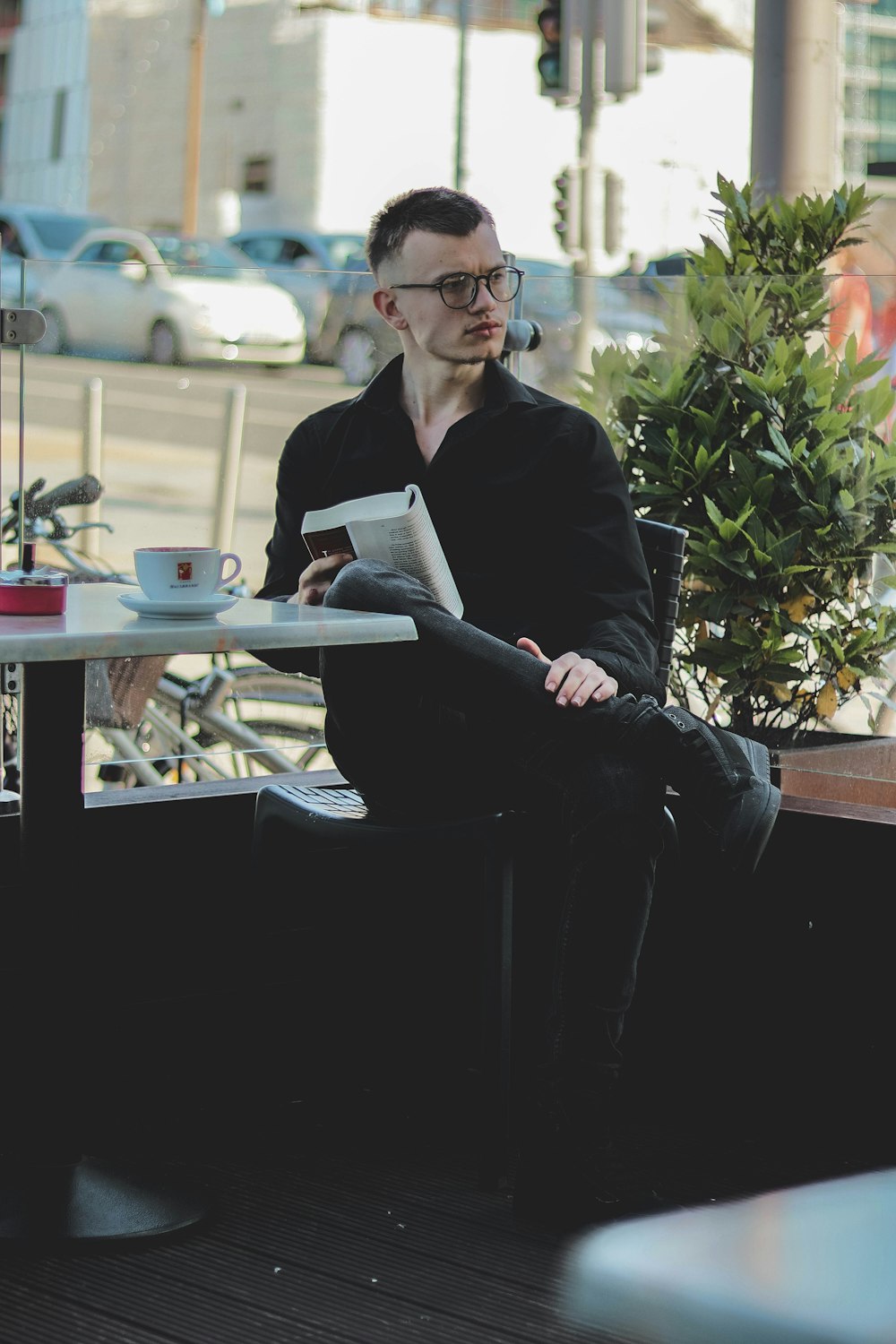 man in black suit reading book