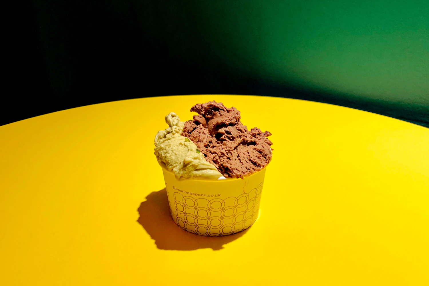 two scoops of Rhubarb and Custard Giggle in a yellow cup — in the freezer today