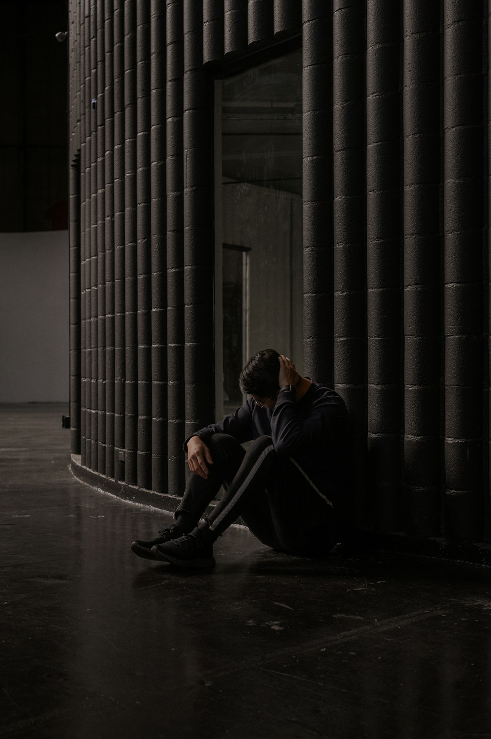 man in black jacket sitting on black chair