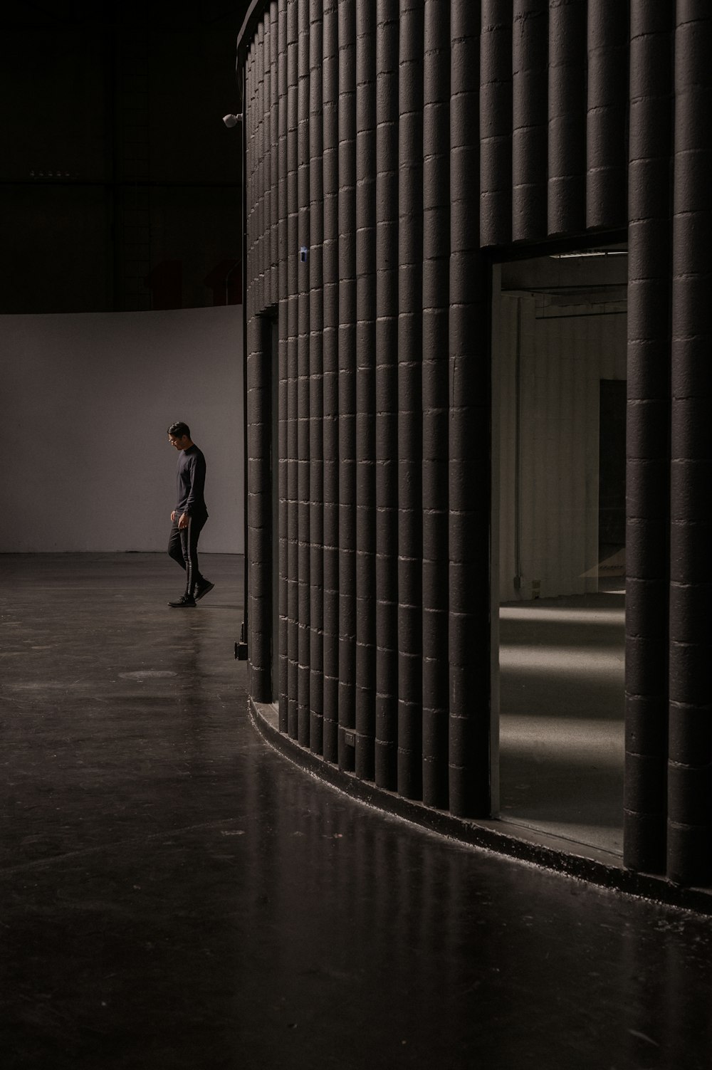 woman in black jacket walking on hallway