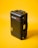 A black hard-shell protective case labeled 'Pelican Air' stands upright against a bright yellow background. The case features robust construction with secure clasps and a handle on the side.