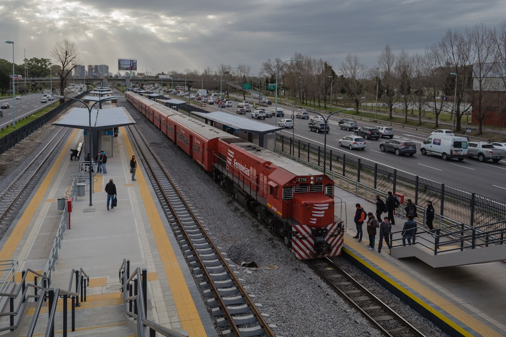 red train on rail road during daytime