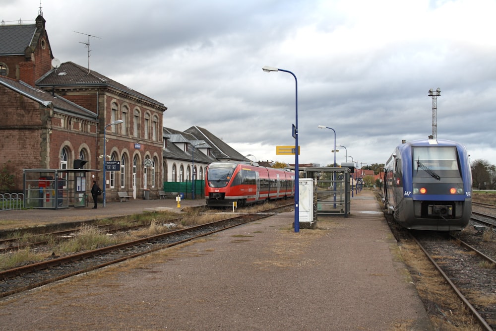 red and white train on rail road during daytime