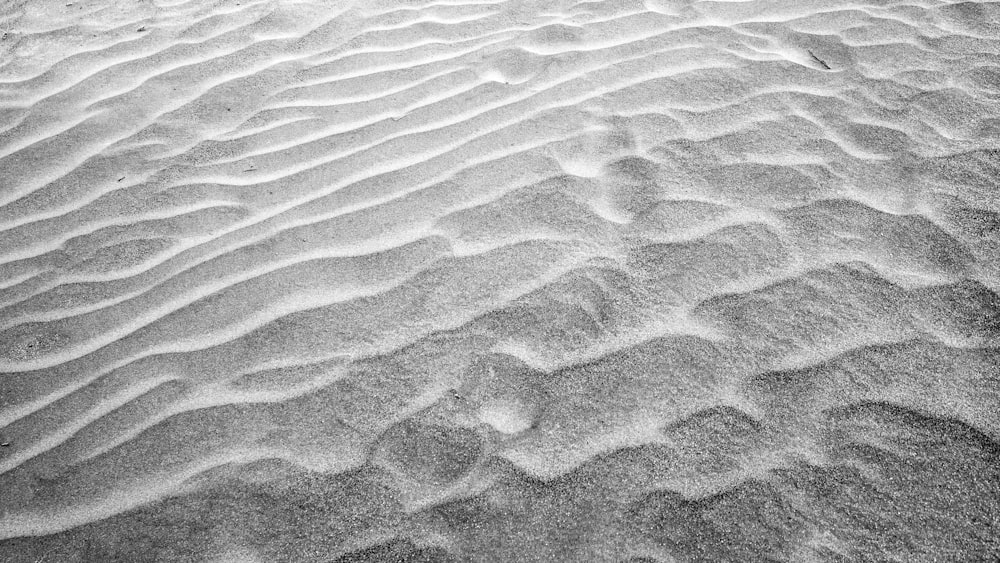 brown sand with footprints during daytime