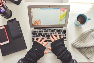 person in black long sleeve shirt using macbook pro